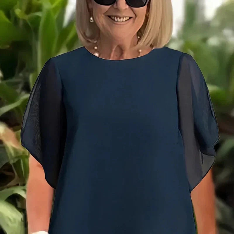 Encantador conjunto de blusa irregular e calças pantalona